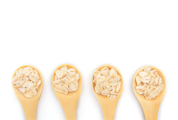 Top view of dry rolled oatmeal in wooden spoon isolated on white background.