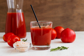 tomato juice and fresh tomatoes.glass of Tomato juice with pink salt. Healthy drink with tomato juice in a glass isolated on a white background with copy space