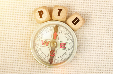 On the table is a compass and cubes with the inscription -PTD