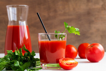 tomato juice and fresh tomatoes. glass of Tomato juice with parsley. Healthy drink with tomato juice in a glass isolated on a white background with copy space.