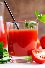 close-up glass of Tomato juice with parsley. Healthy drink with tomato juice in a glass isolated on a white background with copy space. vertical