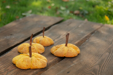 Pumpkin cookies on desk on green grass