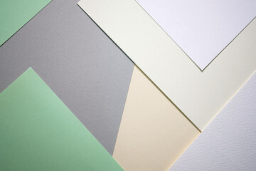Abstract background from sheets of white, gray and green paper.  background with geometric shapes. Thick paper of different colors top view. Abstract paper - colorful background, creative design
