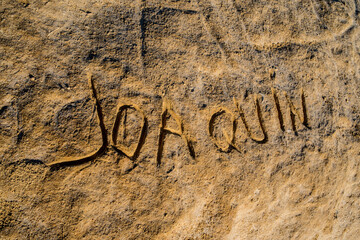 Etched in the rock with the proper name 