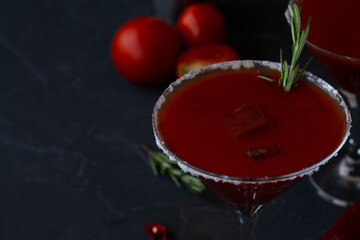 tomato juice in glass.close-up Bloody Mary cocktail. Alcoholic drink with vodka and tomato juice in a glass isolated on a black background. vampiro cocktail with pepper on table. copy space.