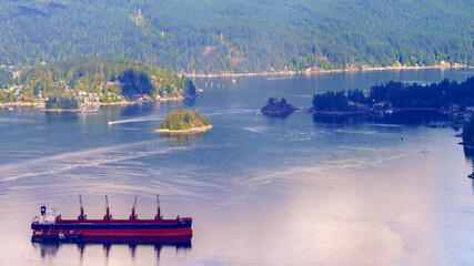 Fototapeta na wymiar Shipping on beautiful Burrard Inlet near town of Deep Cove, BC, Canada