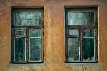 View of two windows of an old stone Russian house.