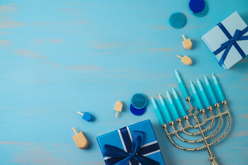 Jewish holiday Hanukkah background with menorah and gift box on wooden table