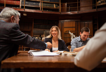 Students preparing exam and learning lessons in school library