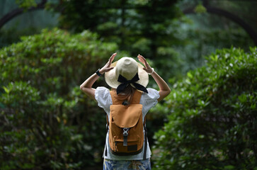 the woman clutches her head in emotions of delight and surprise from the beauty of nature