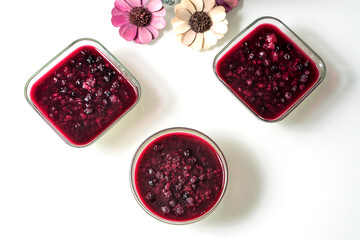Blueberry jam in glass bowls on a white table, selective focus