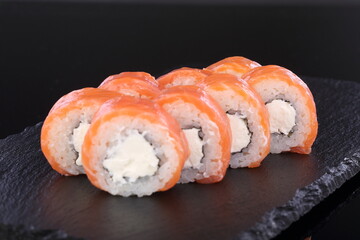 sushi on a black plate