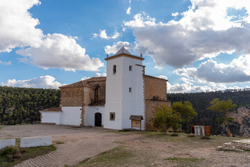 Fototapeta premium Sanctuary of the Christ of Life in Villa de Ves, with a natural landscape in an afternoon of sun and clouds.