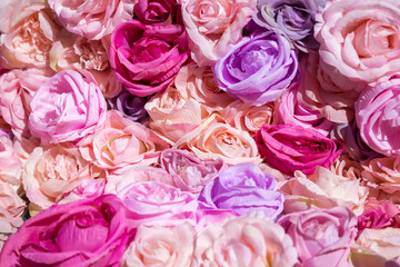 Floral background with colorful artificial roses. Flowers Pattern background