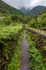 Fototapeta na wymiar A water canal under the hills around Saiko lake, Japan.