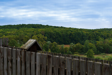 Fototapeta na wymiar Wildlife view of the village above the rustic wood fence