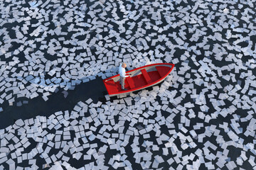 businessman on a boat sailing the ocean of paper sheets  © Photobank