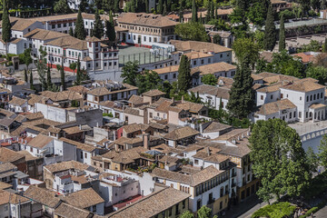 Obraz premium Beautiful aerial view city of Granada in a daytime. Granada - capital city of province of Granada, located at foot of Sierra Nevada Mountains. Granada, Andalusia, Spain.