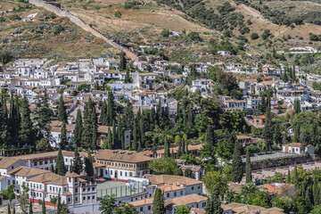 Fototapeta premium Beautiful aerial view city of Granada in a daytime. Granada - capital city of province of Granada, located at foot of Sierra Nevada Mountains. Granada, Andalusia, Spain.