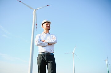 Businessmen engineering standing handsome smile front of turbine looking away