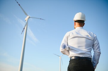 Businessmen engineering standing handsome smile front of turbine looking away