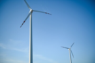 Wind Turbines in a Green Field and Blue Sky.