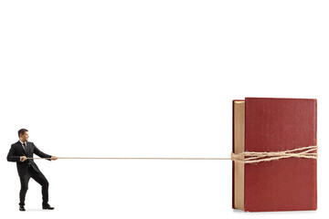 Full length profile shot of a professional man in a suit and tie pulling a book with a rope