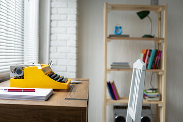 Pen on stack of paper and vintage old typewriter at wood desk table. Writer or study creative