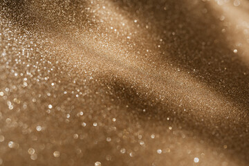 Golden glitter background with small particles