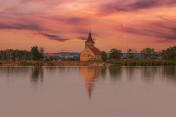 Fototapeta na wymiar Nove mlyny reservoir and in the background the flooded church of St. Linhart and Palava with the ruins Divci Hrady in the Czech Republic.