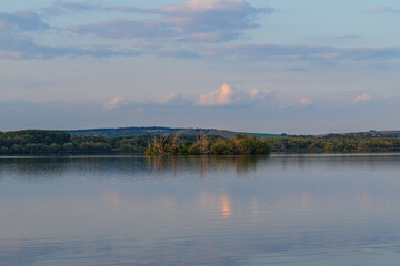 Nove mlyny reservoir and in the background the flooded church of St. Linhart and Palava with the ruins Divci Hrady in the Czech Republic.