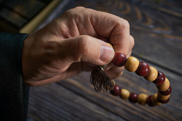 Monk uses wooden beads while praying