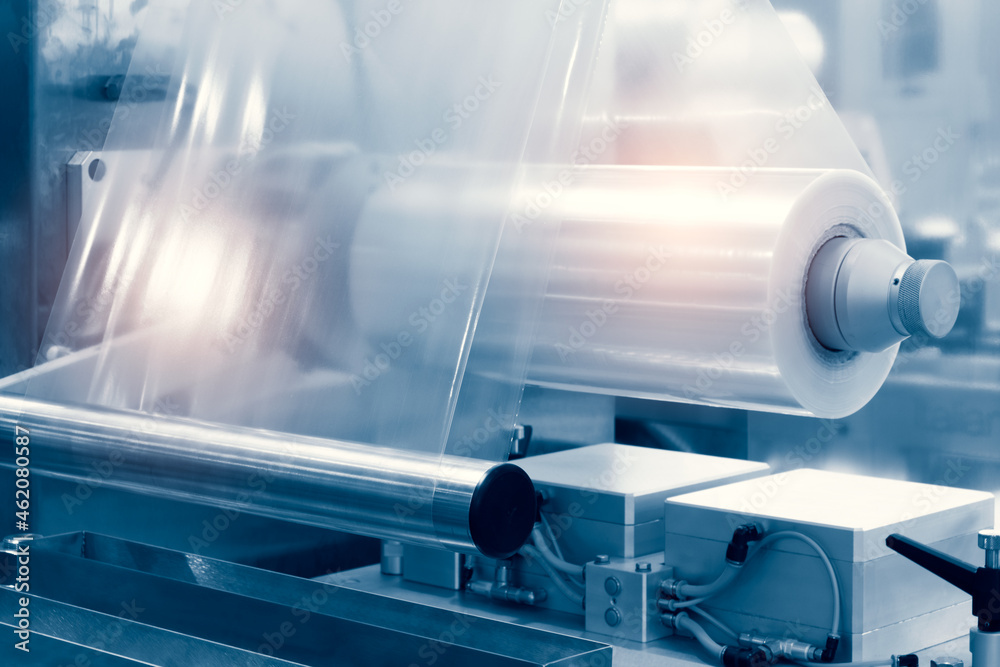 Poster the operation of automatic plastic bag production machine with lighting effect. close-up of the roll