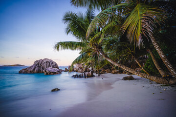 Fototapeta na wymiar Sunset at tropical beach Anse Patates with granite boulders on La Digue Island, Seychelles