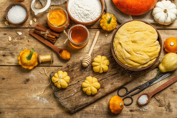 Fototapeta na wymiar Pumpkin buns or biscuits, traditional fall baked goods. Seasonal ingredients for cooking food