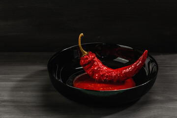 Ripe hot chili pepper on wooden boards background