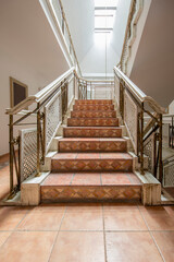 Brown tile stairs and white wood balustrades