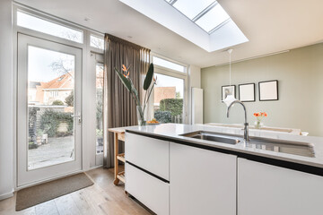 Interior shot of a modern kitchen with decorations and furniture next to an entrance
