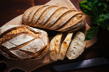 Loaf of sourdough bread on a rustic wooden background in autumn mood