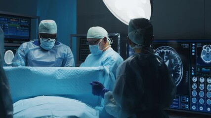 Multiracial team of professional medical surgeons performs the surgical operation in a modern hospital. Doctors are working to save the patient. Medicine, health and neurosurgery.