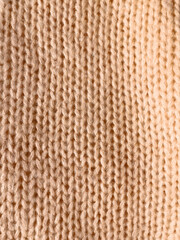 beige knitted background. pigtail texture