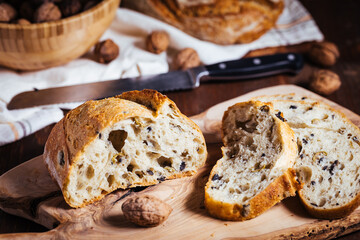 Loaf of sourdough bread on a rustic wooden background in autumn mood