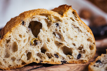 Loaf of sourdough bread on a rustic wooden background in autumn mood
