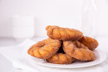 Cinnamon sugar Churro donuts stacked on a plate