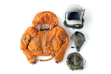 Flat lay of astronaut orange space suit, space helmet and space suit accessories isolated on white...