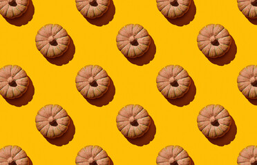 Pattern of pumpkins on yellow pastel background