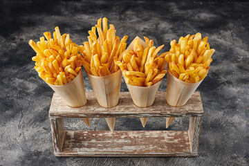 French fries in white paper with holder - obrazy, fototapety, plakaty
