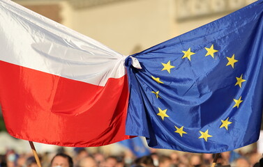 European union flag tied with flag of Poland on public street demonstration to support Poland as membership of EU