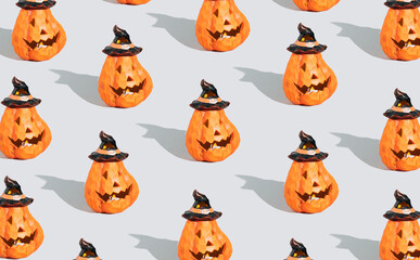 Creative pattern made of Halloween pumpkins or jack O lantern. Minimal holiday celebration background Bright autumn season backdrop.