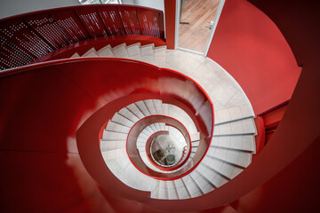 Spiral staircase in office building. Red and white colors. Architecture background